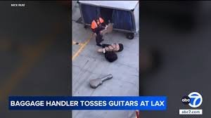temp_image_1774511653.696808 LAX Guitar Tossing Incident: Baggage Handler Faces Backlash