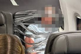 temp_image_1788588743.329251 Chaos Mid-Air: Unruly Aircraft Passenger Restrained with Duct Tape on American Airlines Flight